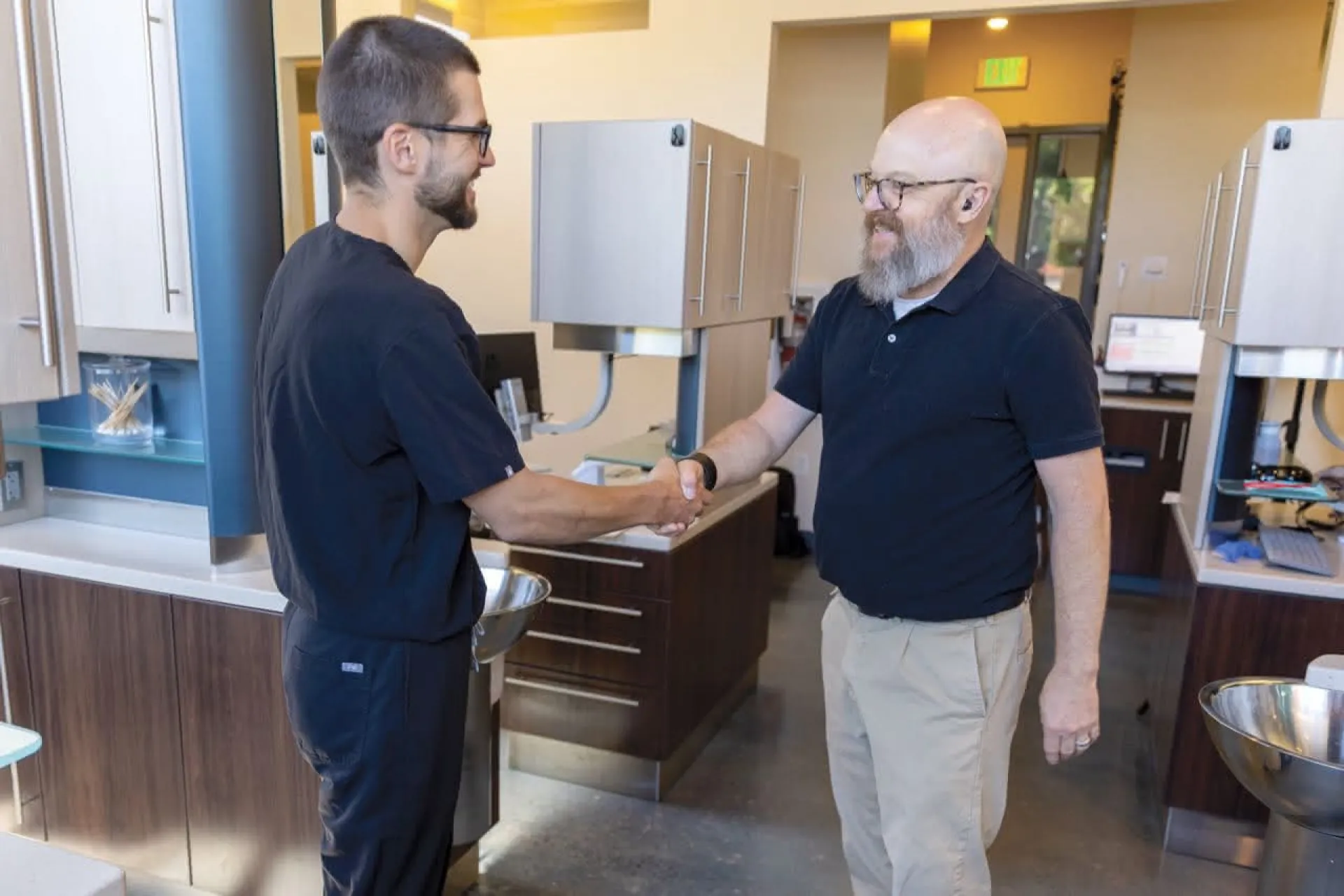 A doctor shaking hands with a patient