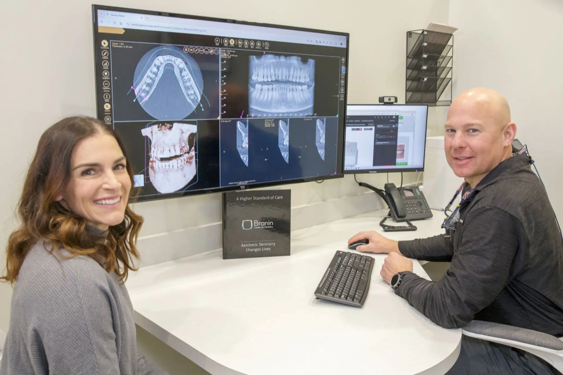 Dr. Dudley and a patient review x-rays on a compter monitor