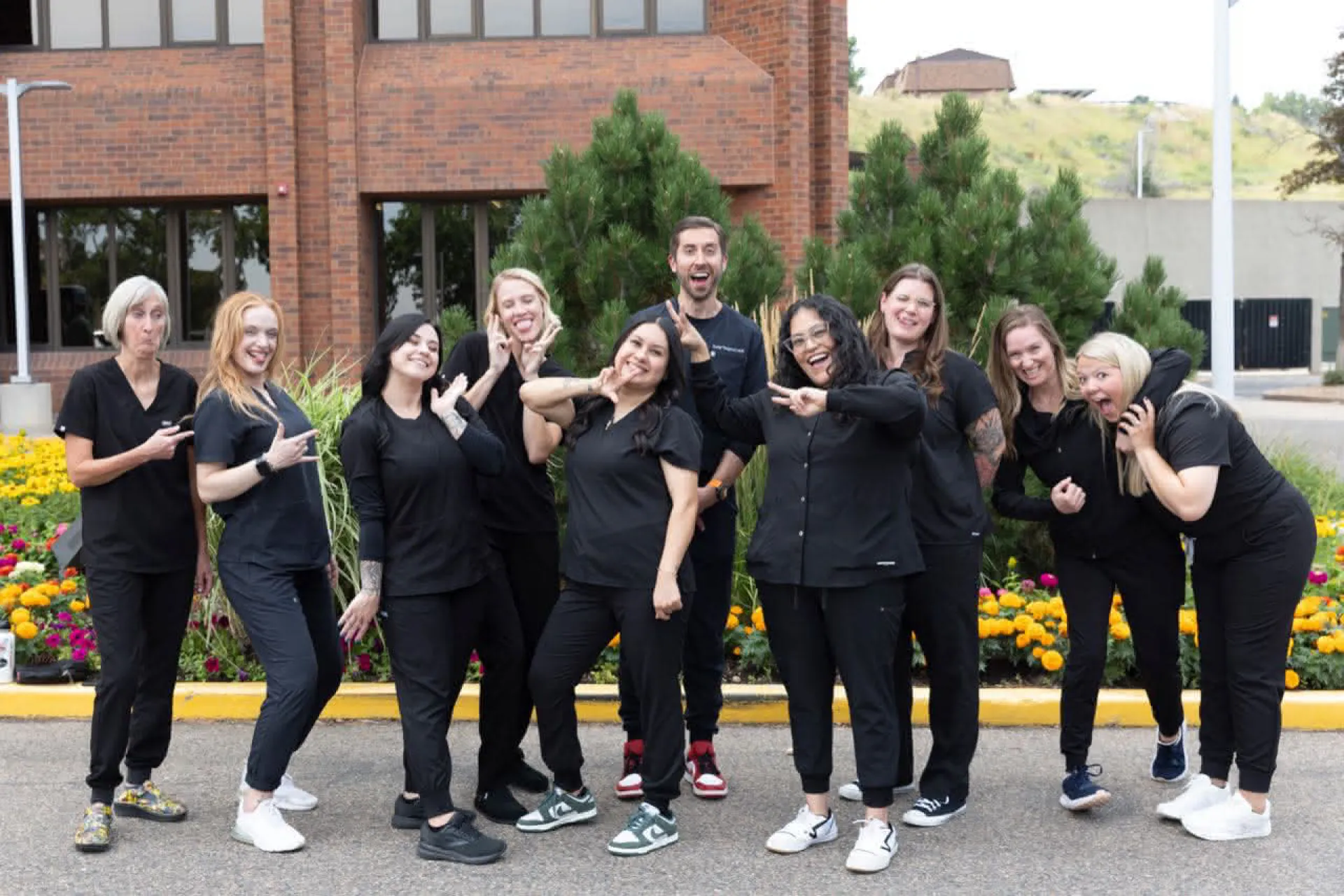 The team at Golden striking interesting poses in front of the office