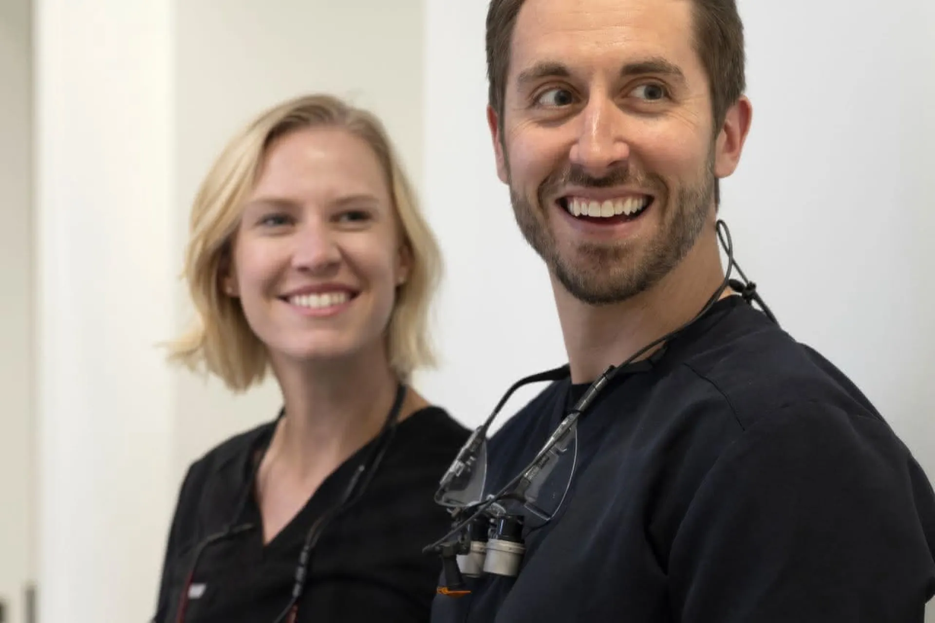 Two dentists smiling back at the camera