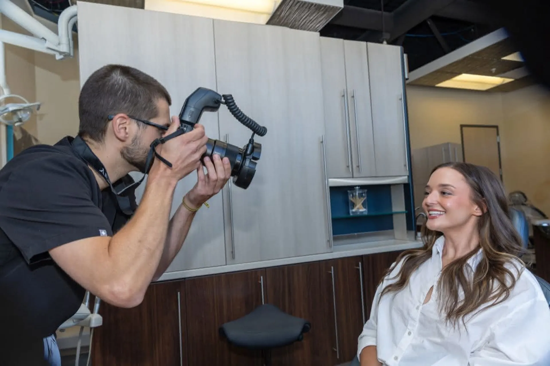 Doctor taking a photo of a patient smiling