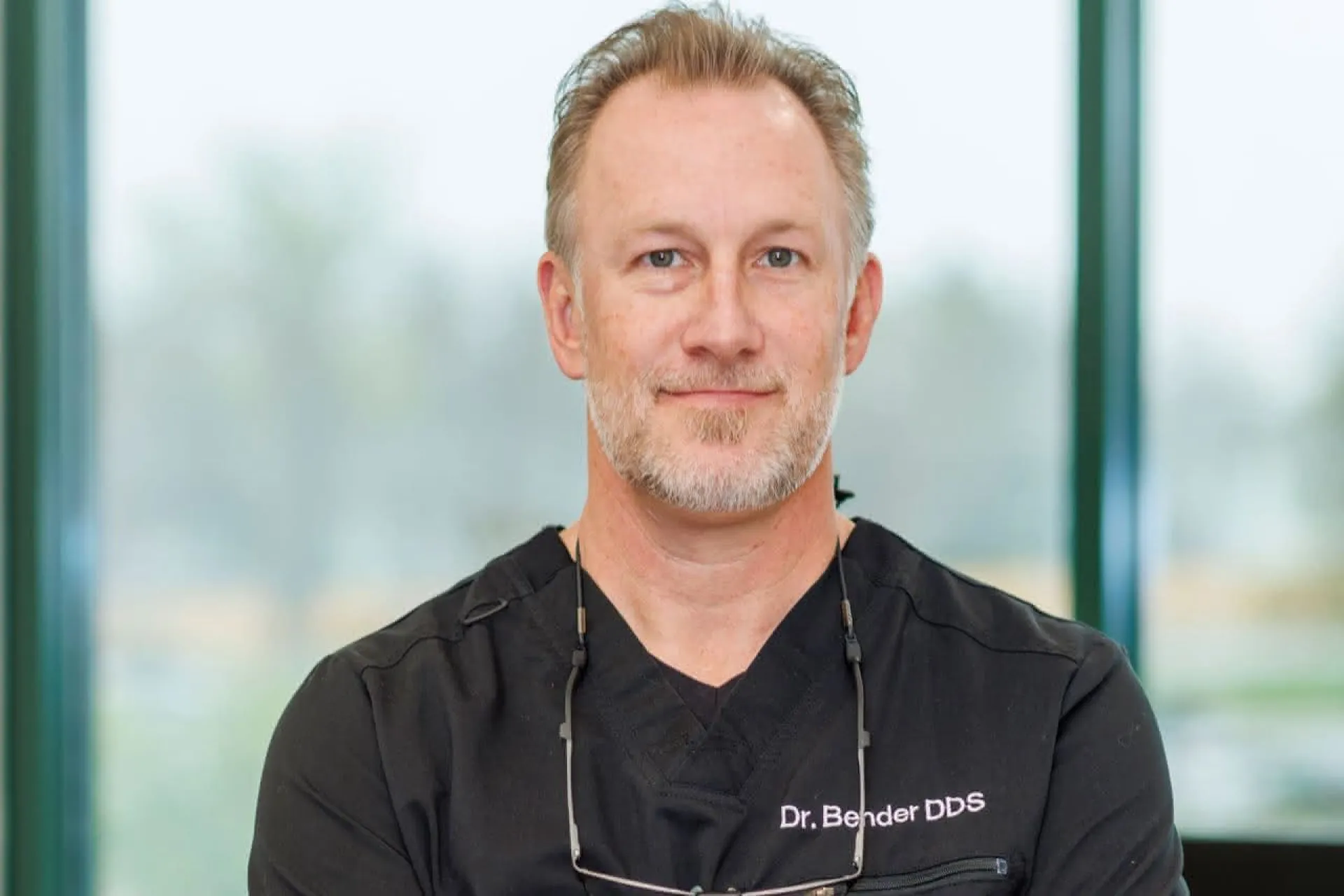 Dr. Bender in front of a window