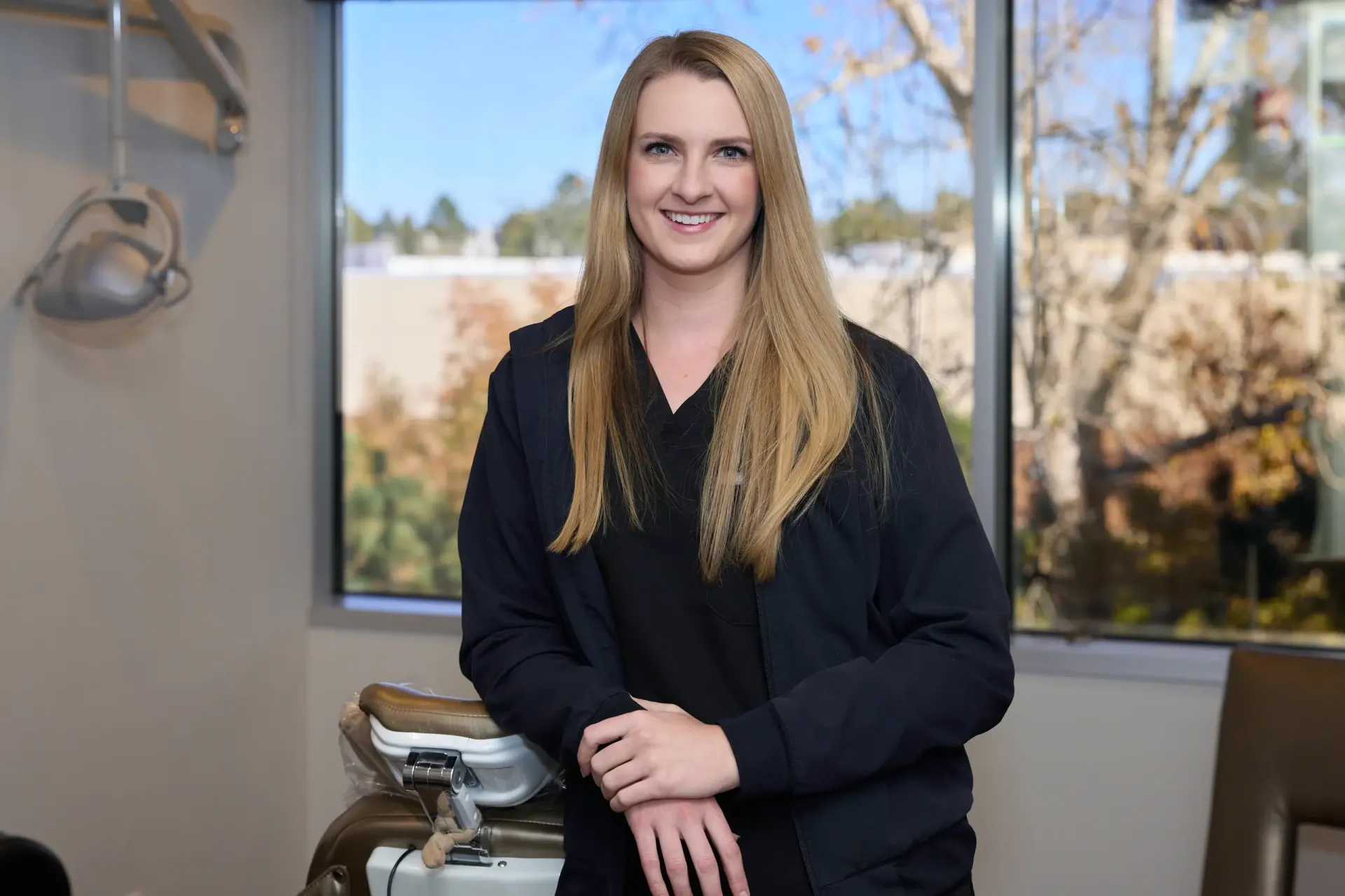 Dr. Gray leaning on a tan chair