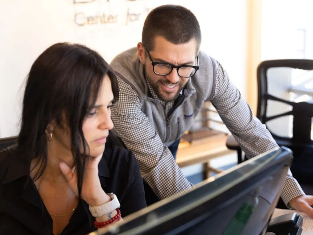 Two doctors looking at a computer monitor