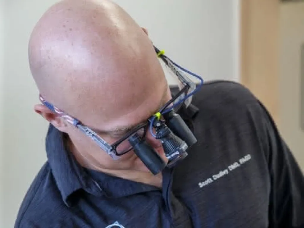 Dr. Dudley wearing a magnification device