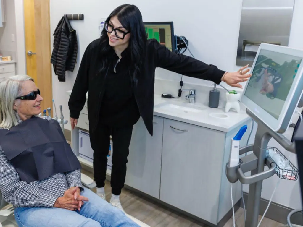 A person explaining a dental procedure to a patient