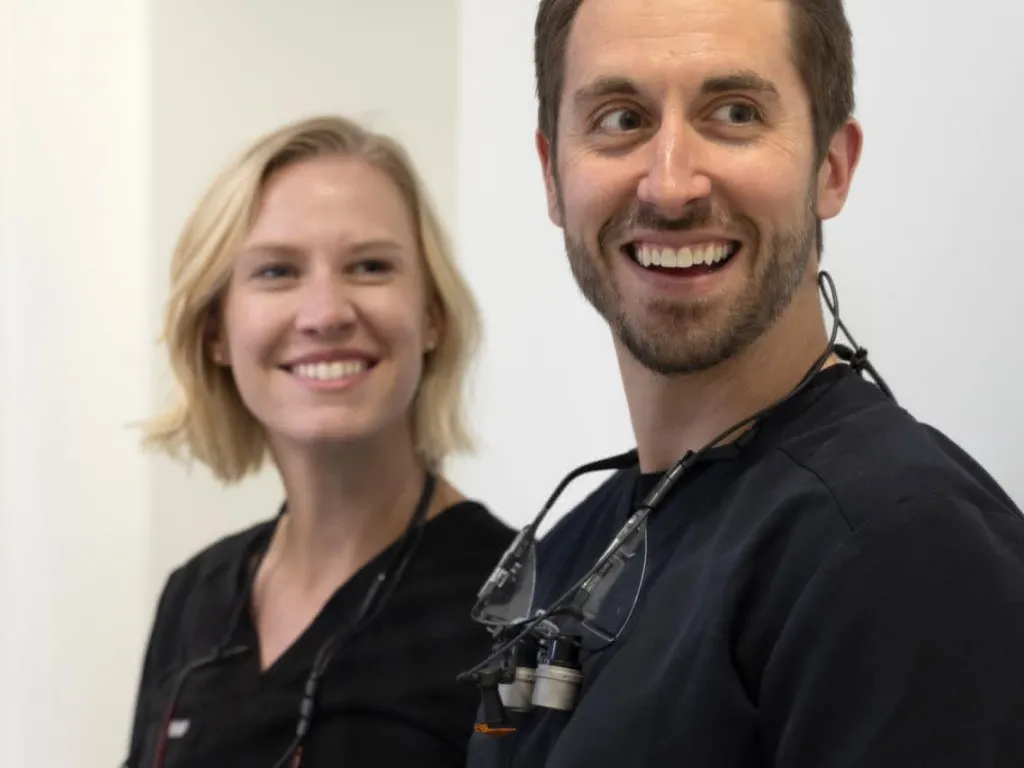 Two dentists smiling back at the camera