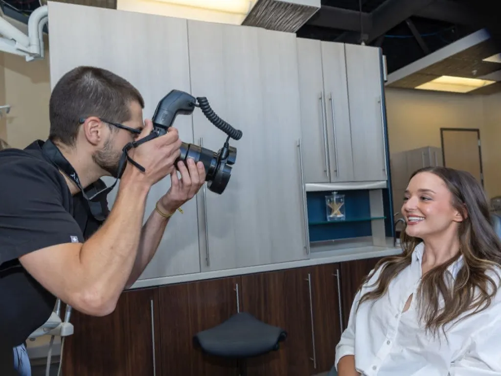 Doctor taking a photo of a patient smiling