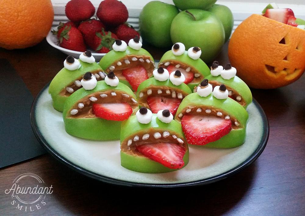 A tray of eight monsters made from apples