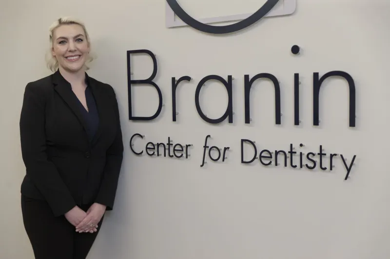 Dr. Sesson in front of the office sign