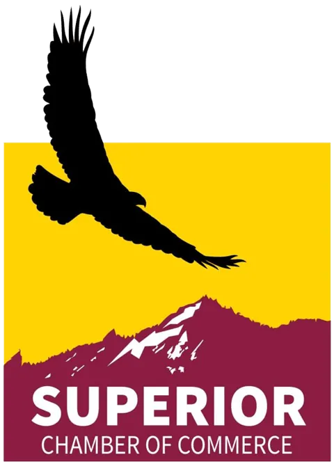 red mountains and a silhouette of an eagle in the sky